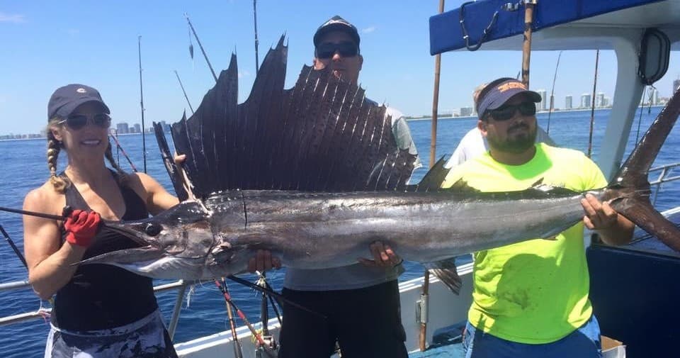 Anglers with sailfish on sportfishing boat off Miami Beach