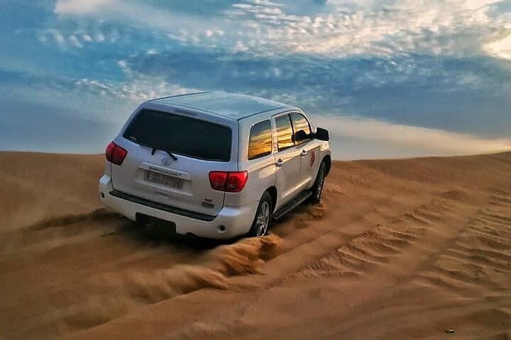 Sunset Desert Safari Dubai: Dune Bashing, Camel Ride & Sandboarding