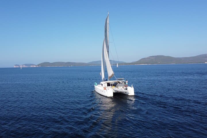 Catamaran Day Cruise from Alghero to Capo Caccia: Snorkel, SUP & Lunch